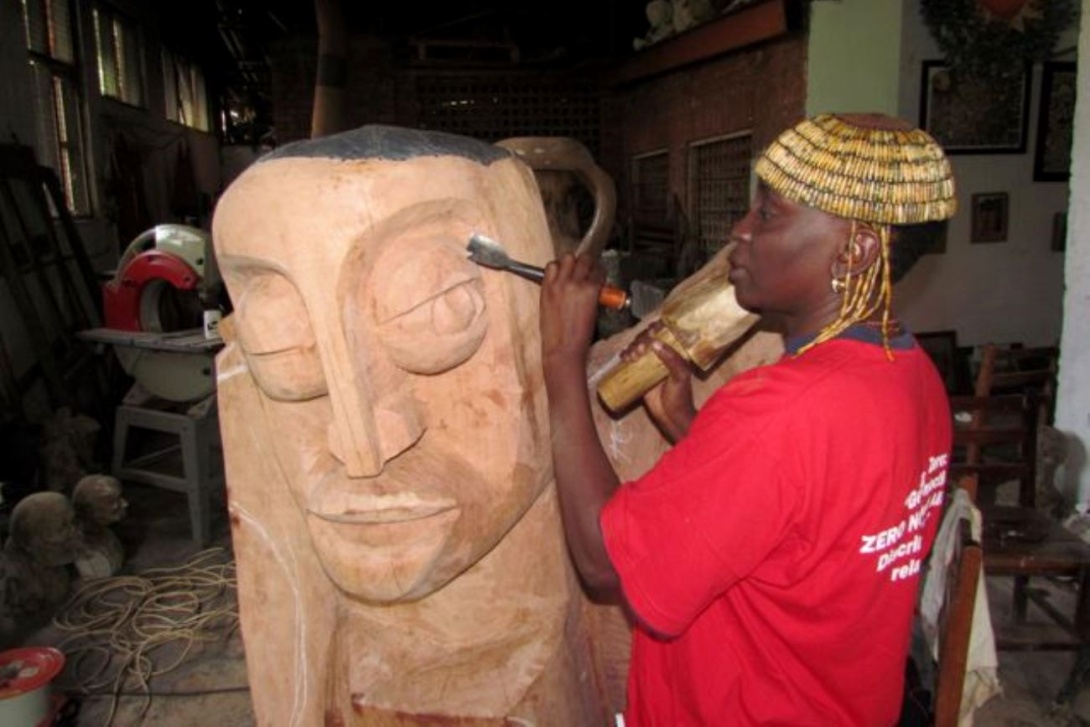  Dr. Lilian Mary Nabulime sculpts a piece of wood at MTSIFA, Makerere University, Kampala Uganda.