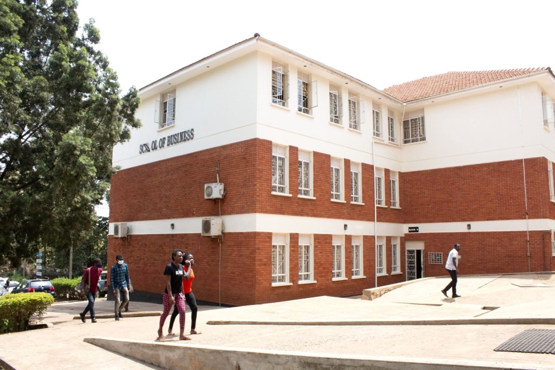 Studens walk past the School of Business (Block B), College of Business and Management Sciences (CoBAMS), Makerere University, Kampala Uganda, East Africa.