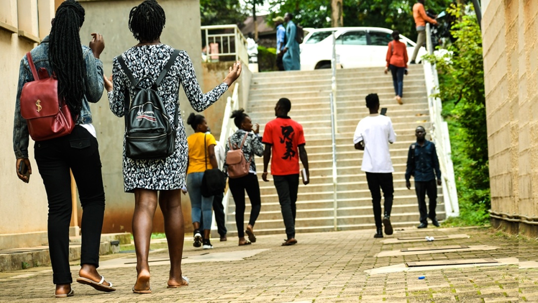 Students stroll past the Frank Kalimuzo Central Teaching Facility-CTF (Left) and School of Social Sciences (Right) on the Makerere University Main Campus.