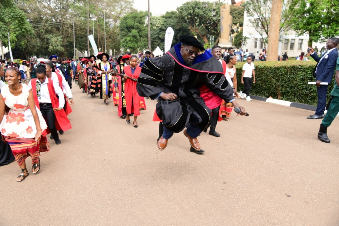 Dr. Milton Wabyona goes airborne as the Department of Performing Arts and Film (PAF) leads the Academic Procession out of the Freedom Square after Day1 of the 75th Graduation Ceremony on 13th January 2025, Makerere University, Kampala Uganda, East Africa.