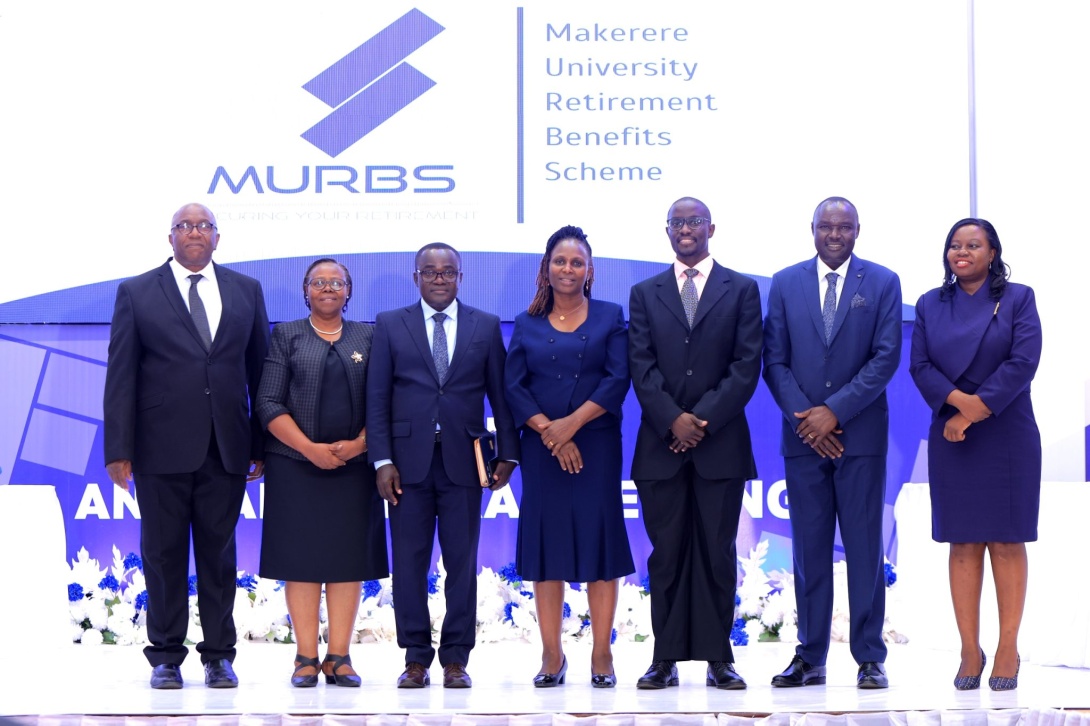 The Chairperson, Dr. Michael Kizito (3rd Right) and Board Secretary, CPA Francesca Angida Mugyema (Centre) with MURBS Trustees from Left to Right: Mr. George Bamugemereire, CPA Edna Rugumayo, Dr. Deus Kamunyu Muhwezi, Mr. Joseph Ikarokok and Dr. Elizabeth Nansubuga at the 15th AGM on 23rd October 2025, Main Hall, Main Building, Makerere University, Kampala Uganda, East Africa.